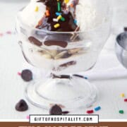 an ice cream sundae with vanilla ice cream, hot fudge sauce, and sprinkles.