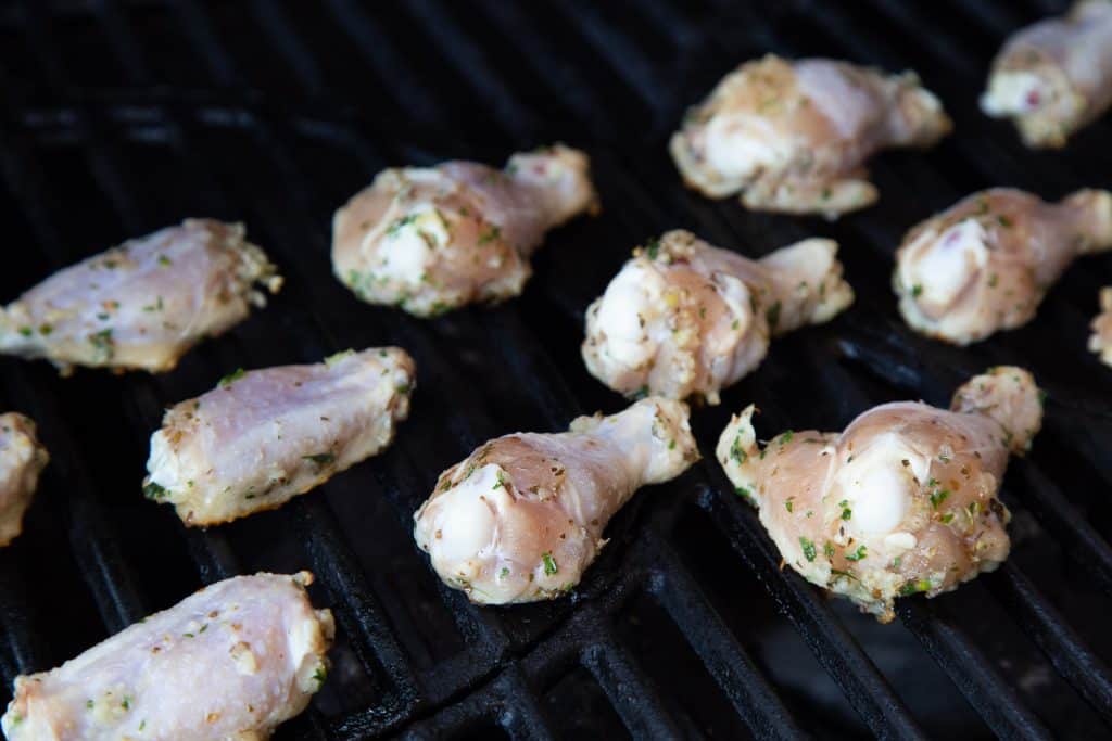 Raw chicken wings on the grill