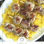 chicken kabobs on a bed of golden rice