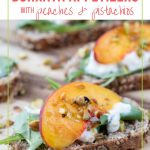 a peach slice, a dollop of burrata, and arugula on a whole wheat toast