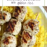 chicken kabobs on a bed of golden rice