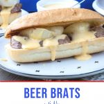 bratwurst slices on a bun with cheese sauce dripping out