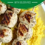 chicken kabobs on a bed of golden rice