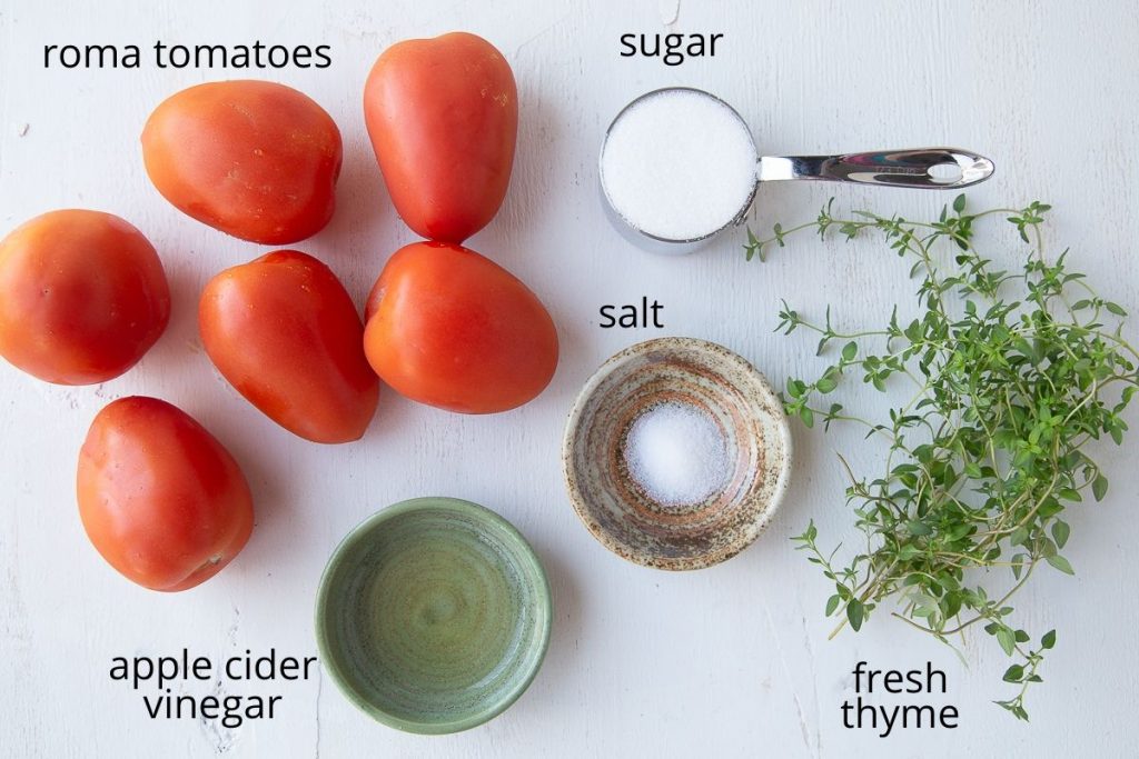 ingredients for tomato jam on a white background