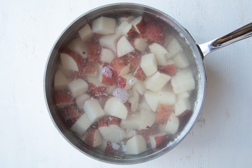 diced red potatoes in a pot of water