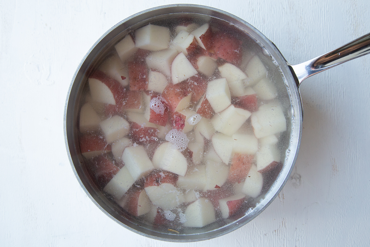 diced red potatoes in a pot of water