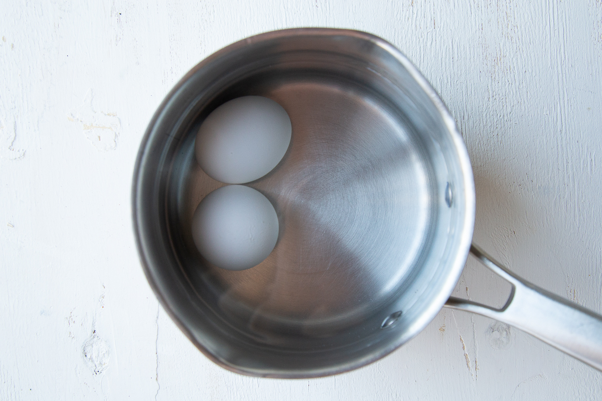 two eggs in a small saucepan, covered with water