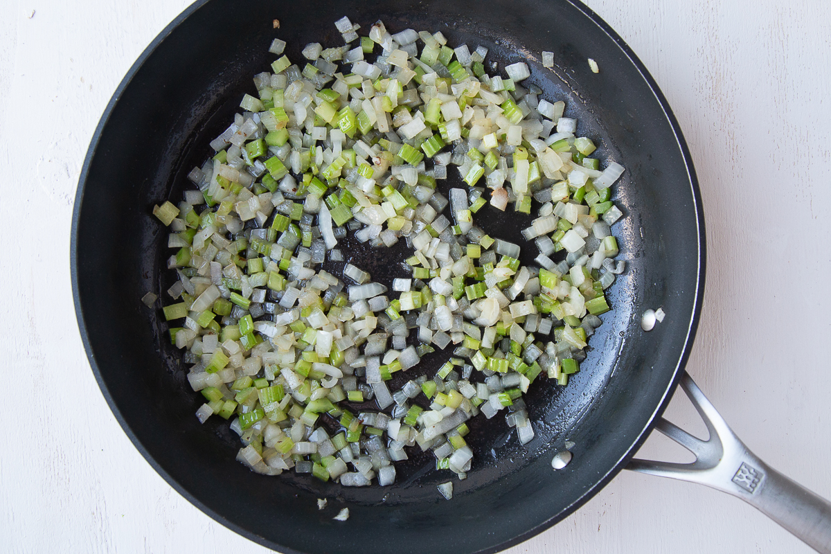 onion and celery cooking in a nonstick pan