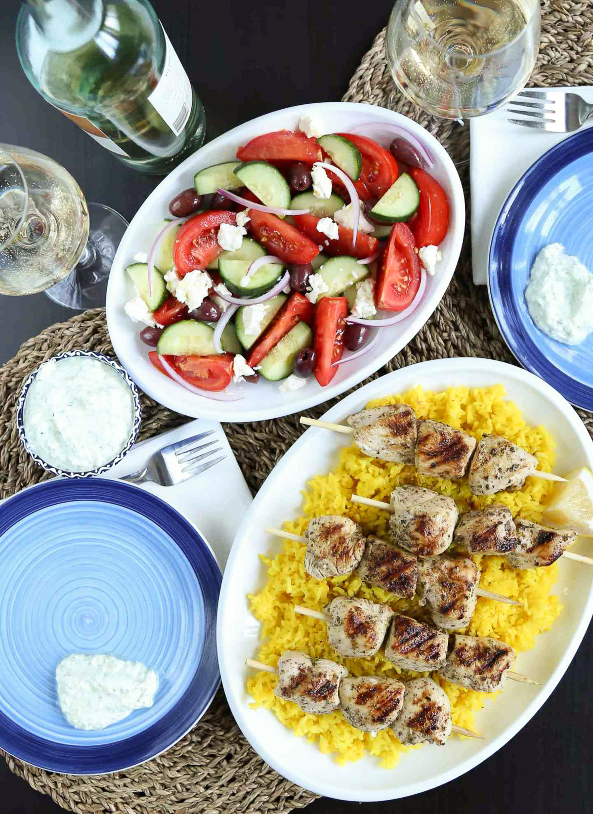 table of Greek food including greek salad and chicken souvlaki