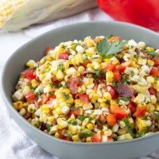 grilled corn salad in a green bowl