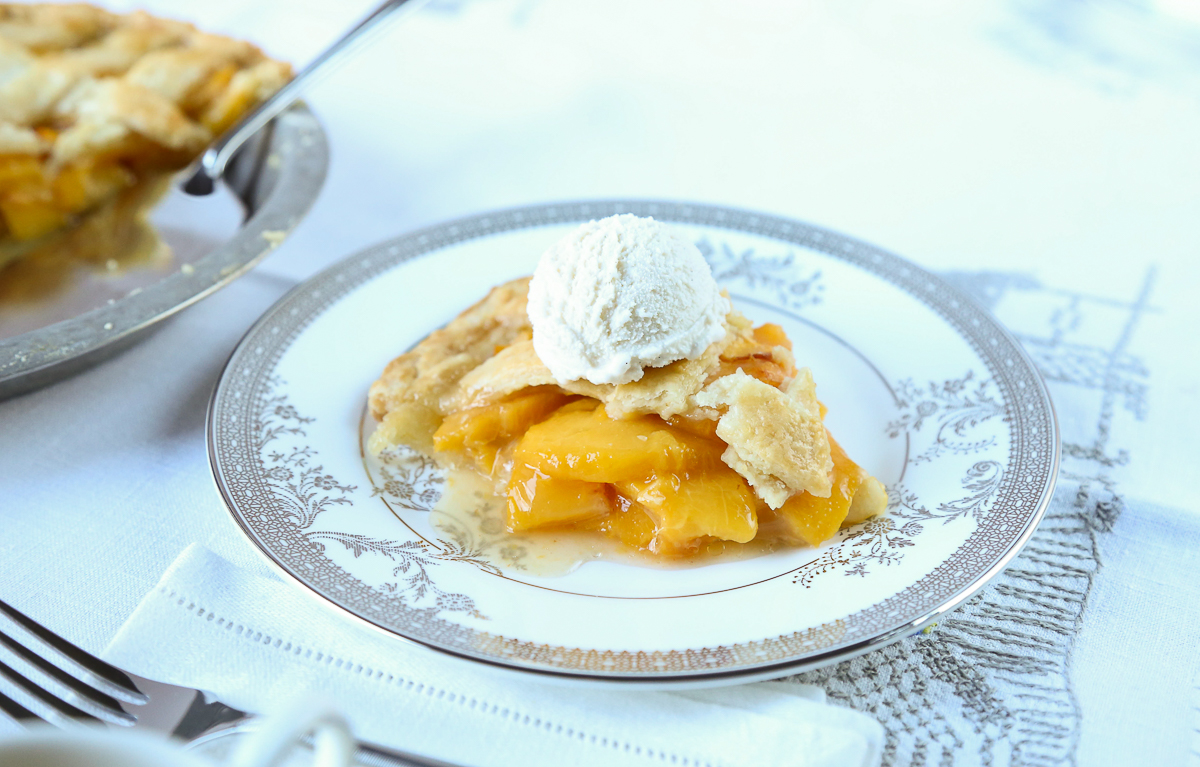 slice of peach pie on a small china plate.