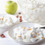 Taffy apple salad in a small white dish with a large glass serving dish in the background