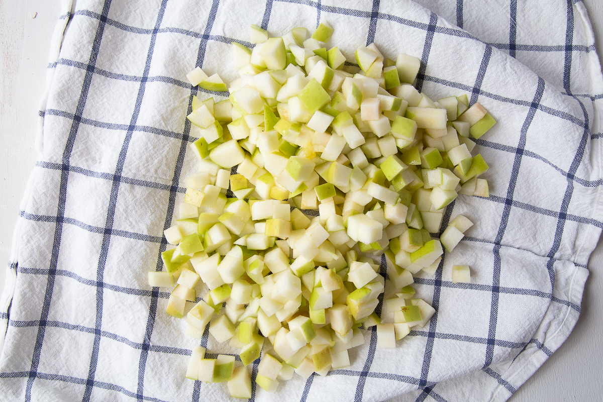 apples being dried on a blue and white tea towel