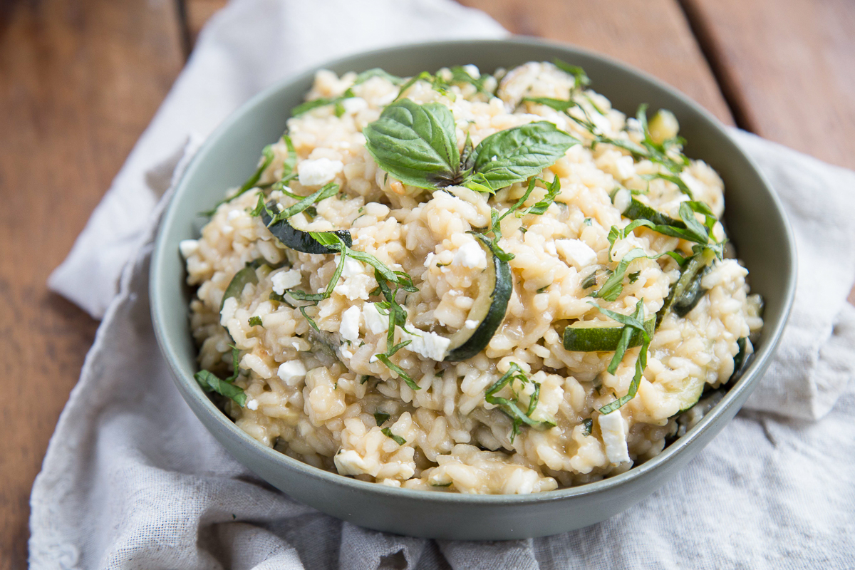 zucchini risotto in a green bowl