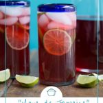 glass of hibiscus tea in a clear glass with a blue rim