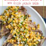 grilled pork chops with peach salsa on a white platter