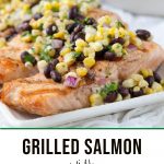 grilled salmon topped with corn salsa on a white platter