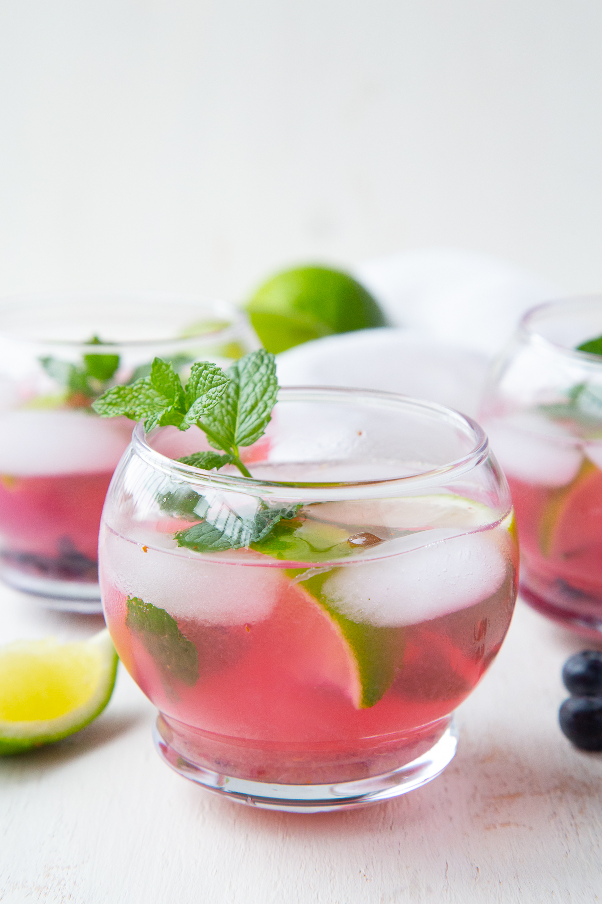 glass of blueberry mojito with fresh mint garnish