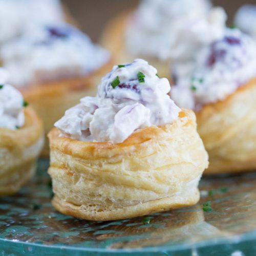chicken salad in a puff pastry cup on a glass serving platter
