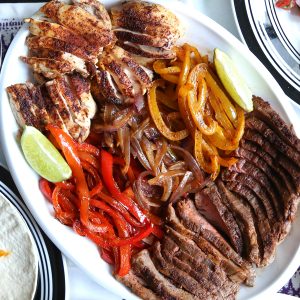 fajitas on a white platter