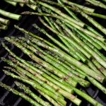 spears of asparagus cooking on a grill