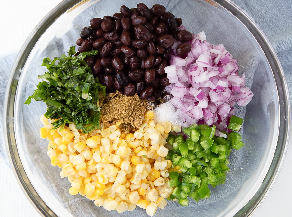 ingredients for corn salsa in a glass bowl