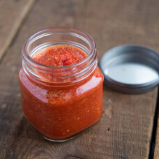 pili pili hot sauce in a glass jar on a wooden table