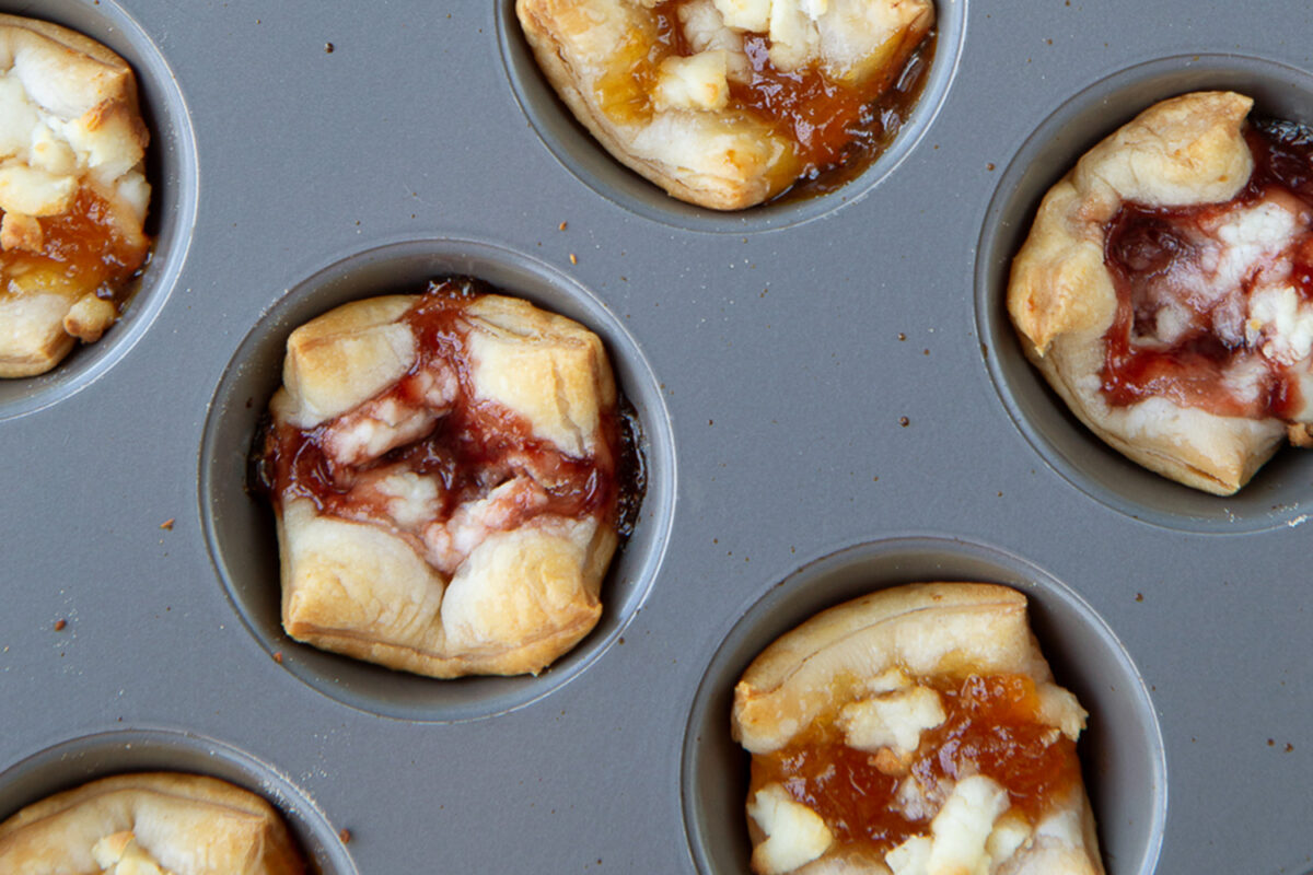 Puff Pastry Bites with Goat Cheese and Jam in a muffin tin
