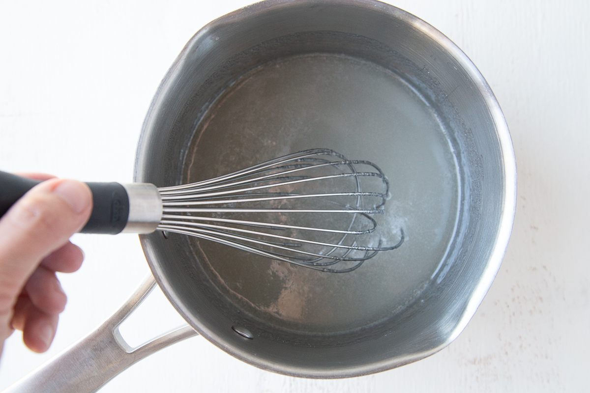 corn syrup and sugar in a saucepan with a whisk