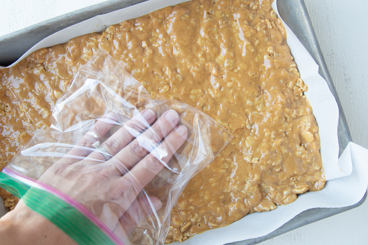 hand inside a plastic bag, pressing on special k bar mixture