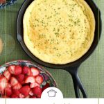 spoon bread in a cast iron skillet on a green tablecloth