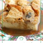 slice of french toast casserole with caramel sauce on top, sitting on a colorful china plate