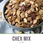 apple cinnamon chex mix in a green bowl on a cream tea towel