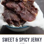 beef jerky sitting in a bowl lined with a cream tea towel
