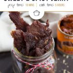 jerky in a glass jar with a red and white ribbon tied around the jar