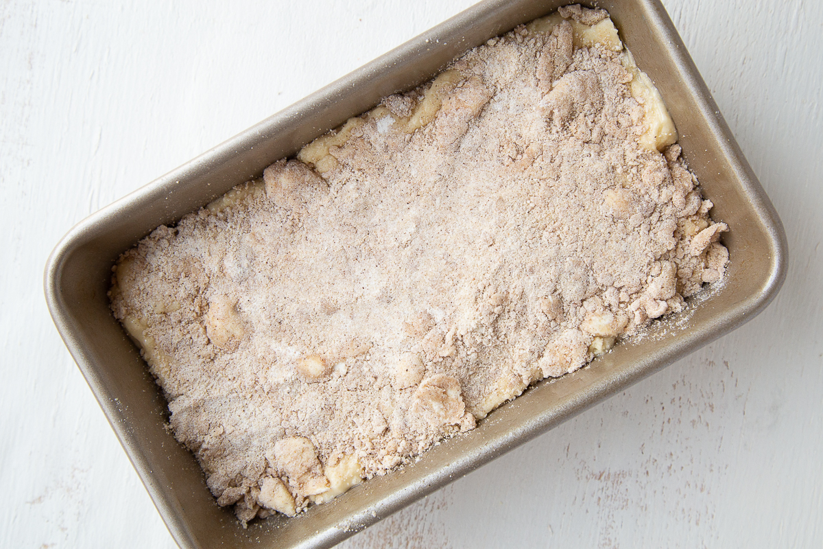 uncooked apple bread with streusel in a loaf pan