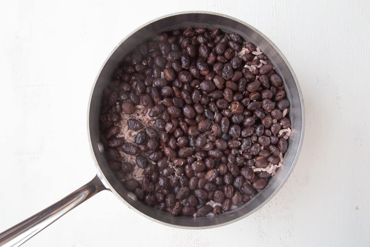 cooked black beans and rice in a saucepan