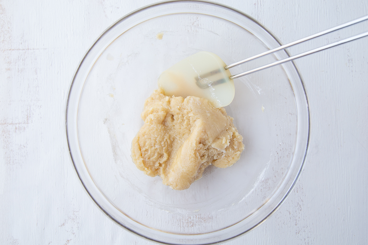 coconut bar dough in a glass bowl with a spatula