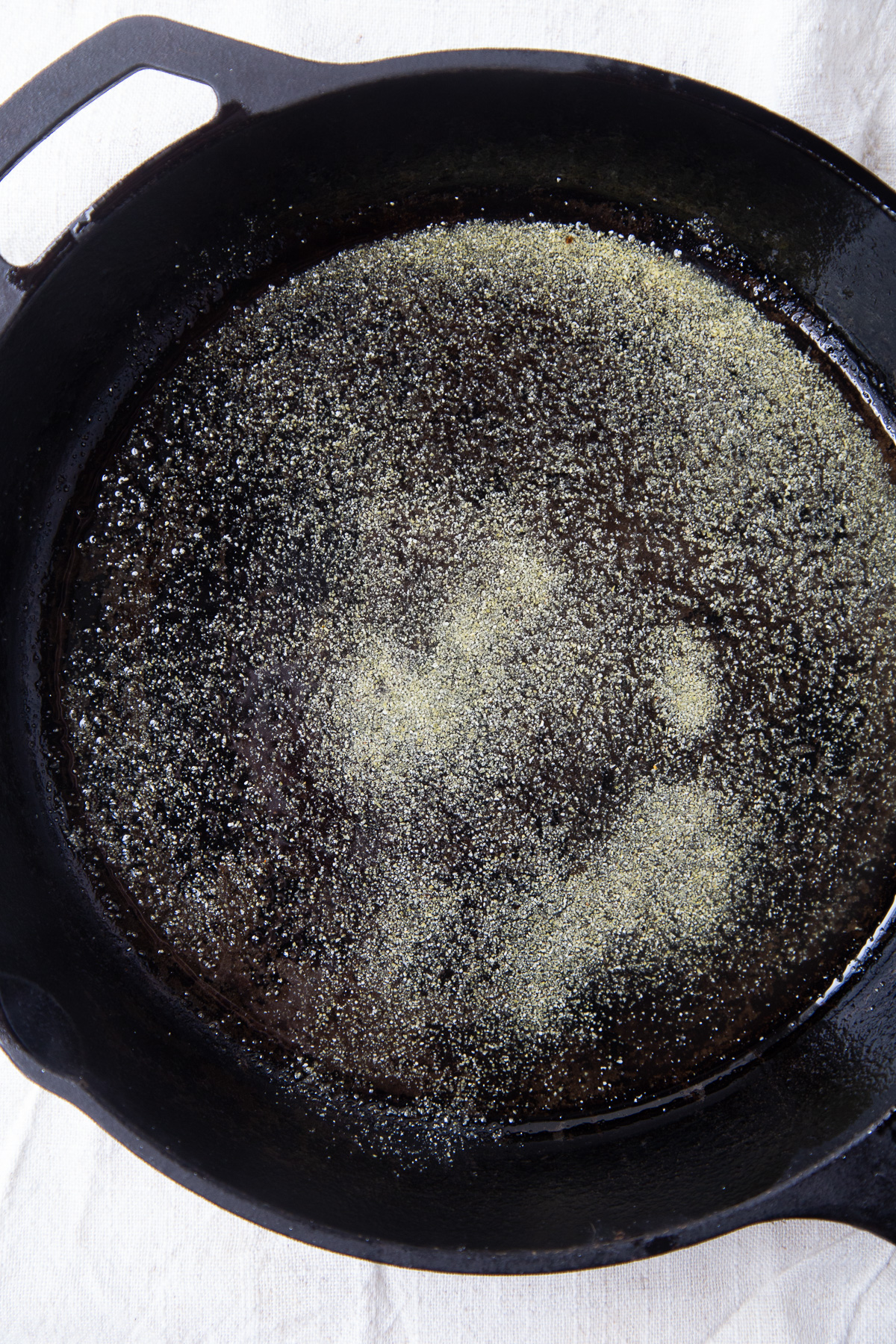 cornmeal and oil in a cast iron pan