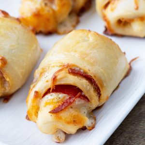 pepperoni rolls on a white platter.