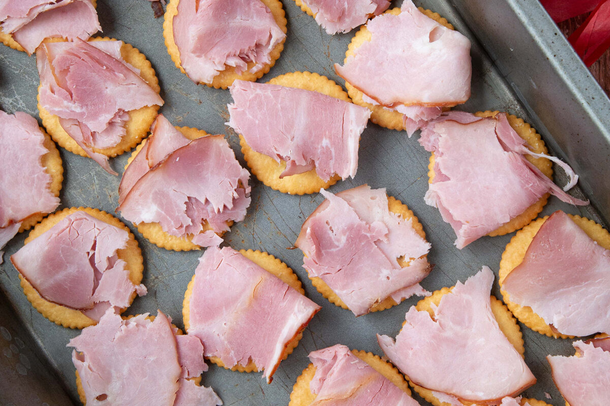 ritz crackers topped with ham in a 13x9 inch pan