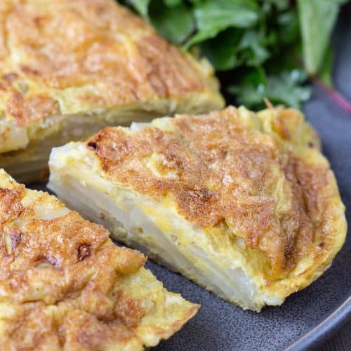 slice of potato omelette on a gray plate.