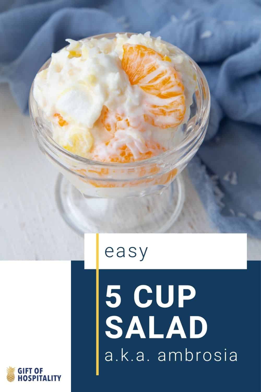 glass parfait dish with ambrosia in it, sitting on a blue towel.