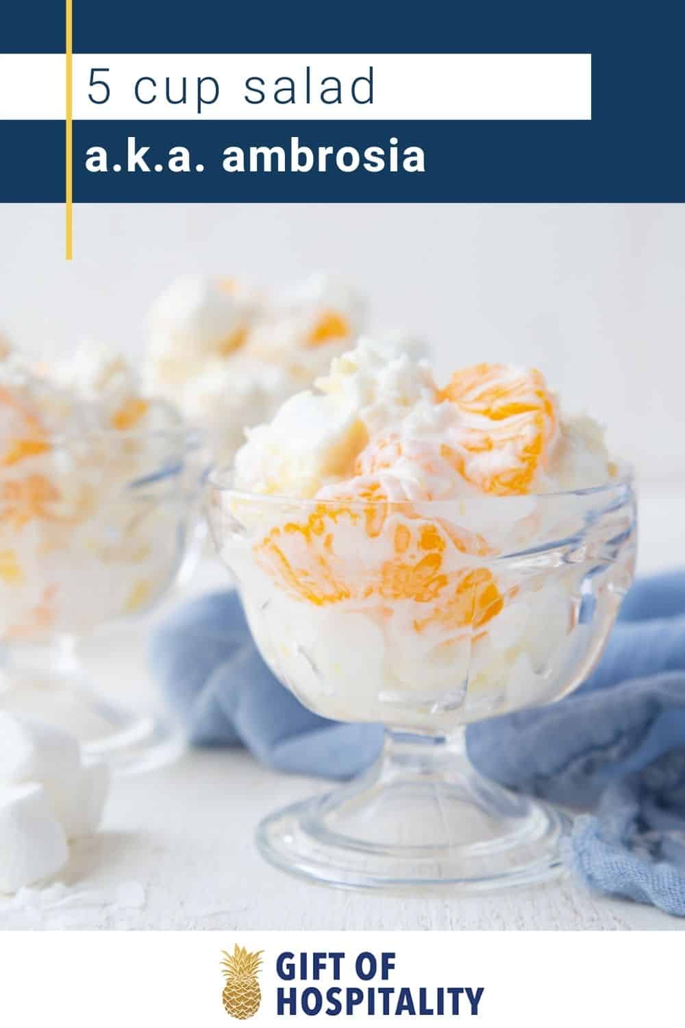 glass parfait dish with ambrosia in it, sitting on a blue towel.