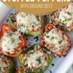 Italian stuffed peppers topped with cheese and parsley in a white casserole dish.