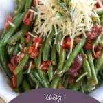 italian green beans in a scalloped white dish on a beige tablecloth.