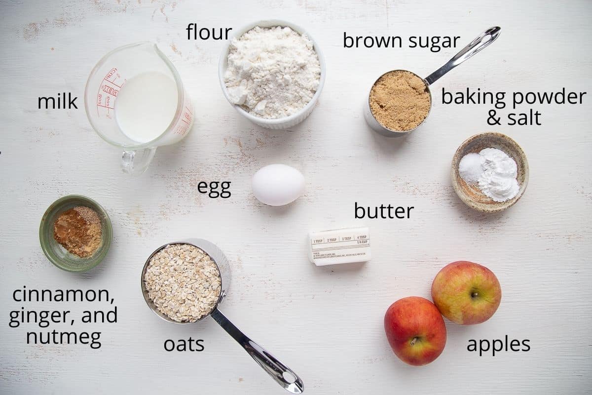 ingredients for apple muffins on a white table.