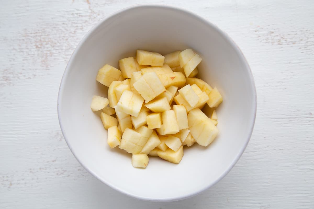peeled and chopped apples in a white bowl.