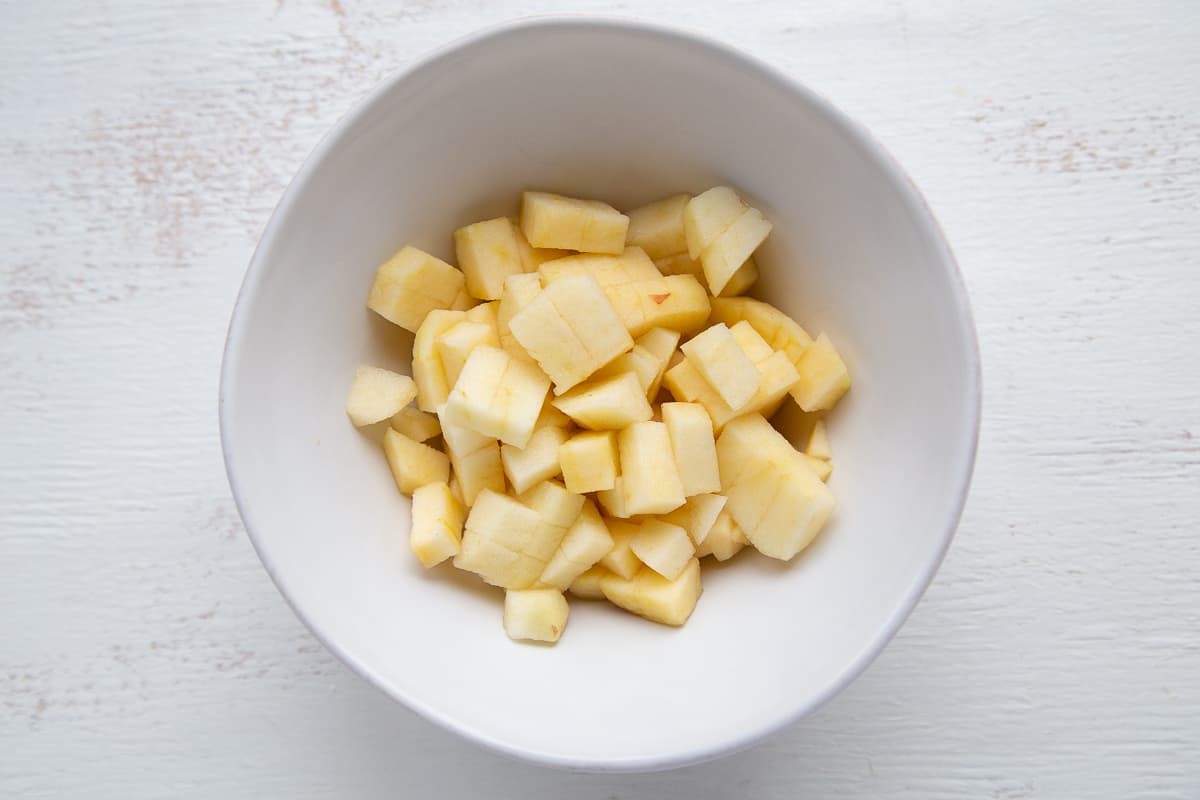 peeled and chopped apples in a white bowl.