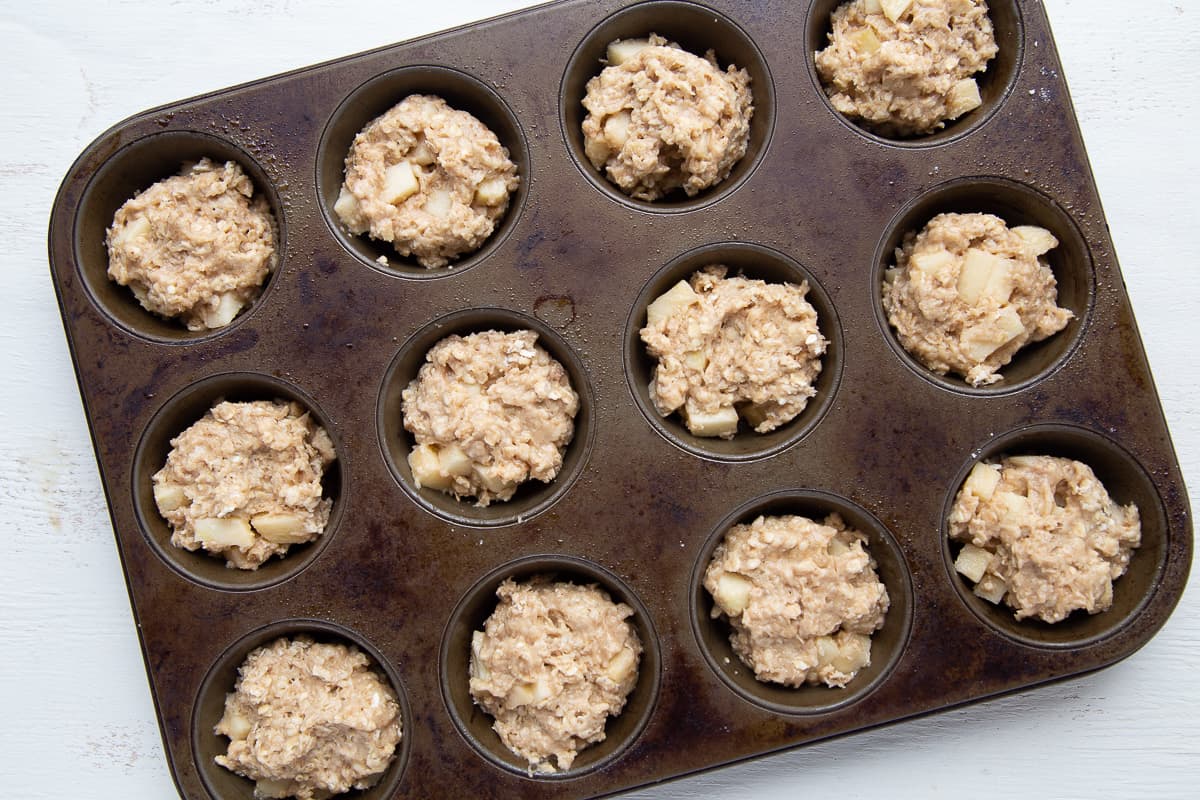 apple muffin batter in a 12 cup muffin tin.